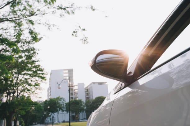 A parked car on the roadside with a sign indicating "Liability Insurance" nearby.